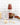 Jar of Zia Pia tomato sauce on a white background with pasta and garlic