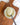 Spoonful of Zia Pia artichoke and garlic spread over a jar on a wooden surface