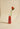 Bottle of Cipriani with a red flower on a beige background