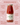 Bottle of Marinara tomato sauce with text highlighting its features on a pink background