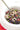 White bowl with a whole grain black rice dish containing vegetables and seafood
