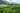 People working in a field with mountains in the background