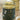 Tea canister labeled 'Camille' by La Via del Te on a wooden surface.