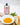 Tin of galantino peperoncino olive oil on a white counter next to the oil in a bowl with bread and basil