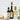 Bottles of Balsamic Vinegar and other condiments on a kitchen counter with a white tiled wall background.