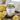 Tea canister labeled 'Ginger Lemon' with lemons and ginger on a wooden surface