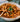 Pasta dish with basil in a bowl on a table