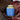 Tea canister with blue label on a patterned fabric background