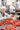 Woman sorting tomatoes in a food processing plant