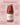 Bottle of Arrabbiata sauce with text highlighting features on a pink background