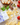 Pasta di Liguria organic fusilli on a counter with basil, bread, tomatoes and other foods.