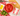 Red bowl of San Marzano tomatoes on a table with a red and white can of tomatoes
