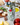 Green and white hand painted ceramic bottle of olive oil on a white counter with cheese and basil.