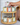 Hand reaching for a garlic olive oil tin on a stack of other olive oil tins