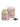 A La Via del Té branded tea tin labeled 'Kate' with a pink background and green leaves, accompanied by a pink box, alongside a scattered pile of green tea leaves.