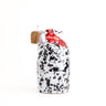 A hand-painted ceramic bottle of lemon-fused extra virgin olive oil with a cork seal and a red label.
