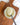 Spoonful of Zia Pia artichoke and garlic spread over a jar on a wooden surface