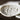 Close up of croxetti pasta on a dark background.