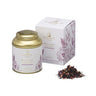 A tin of Rosehip & Blueberry Herbal Tea by La Via del Tè with its packaging box, alongside a small pile of dried tea leaves and berries.