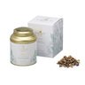 A tin and a box of Ninna Nanna Herbal Tea by La Via del Té with dried tea leaves and herbs displayed in front of them.