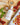 Bottle of Zia Pia olive oil on a wooden board with tomatoes and basil