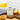 Galantino lemon flavored olive oil tin on a wood cutting board with lemons on a wood countertop on a white background