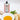 Tin of galantino peperoncino olive oil on a white counter next to the oil in a bowl with bread and basil