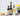 Bottles of Balsamic Vinegar and other condiments on a kitchen counter with a white tiled wall background.