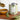 Tin of rosemary flavored olive oil on a wooden board with rosemary sprigs and a oil being poured into a bowl