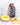 Bottle of olive oil, salt and pepper, and pasta on a wooden board with a tiled wall background.