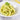 Fausilli Capril in a green sauce in a white bowl