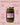 Jar of Zia Pia pesto alla genovese with purple label on a pink background