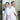 Two men in white shirts standing back-to-back in a warehouse setting.