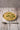 Risotto with peas in a white bowl on a wooden table
