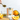 Orange and white striped tin of orange olive oil surrounded by orange slices