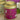 Pink tea canister with gold lid labeled 'Violetta' by La Via Del Te on a wooden surface.
