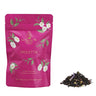Pink tea packaging labeled 'Violetta' with loose leaf tea on a white background