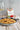 Tomato and Rosemary risotto in a plate on a wooden table with wine and a spoon.