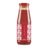 A glass jar containing red tomato puree with a red cap and a label featuring white hearts pattern.