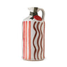 A ceramic bottle of extra virgin olive oil with red striped patterns and a hand-painted design